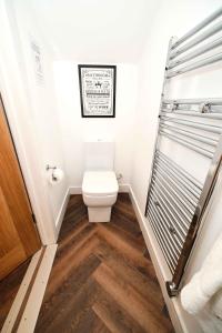 a small bathroom with a toilet and a shower at Hello Stays in Stafford +88 photos