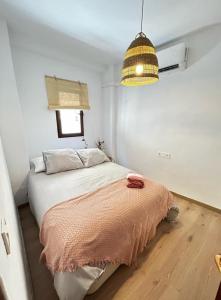 a bedroom with a bed and a pendant light at El Secreto de Lanjarón in Lanjarón
