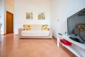 a living room with a couch and a flat screen tv at Οικια in Avola +56 photos