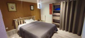 a small bedroom with a bed and a closet at La maison du pêcheur in Livinhac-le-Haut