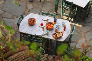 a table with food and a basket of fruit on it at Atlantis Rooms in Ágios Konstantínos
