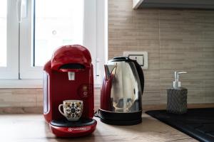 a red coffee maker sitting on top of a counter at Donnalucata - 2min dal Mare e AC in Donnalucata
