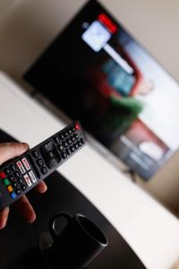 Televízia a/alebo spoločenská miestnosť v ubytovaní ONE Apartament WROCŁAW