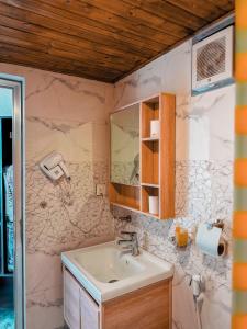 a bathroom with a sink and a mirror at Rum warm bubble camp in Wadi Rum