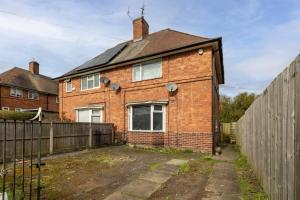 a brick house with a fence in front of it at Luxury Studio with Free Parking in Nottingham