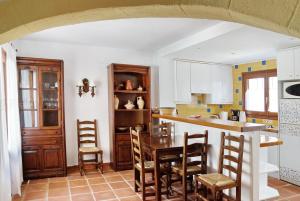 a kitchen with a table and chairs in a room at Adosado La racona in Denia