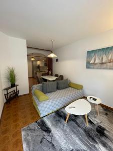 a living room with a couch and a table at Apartments Šestan in Novalja