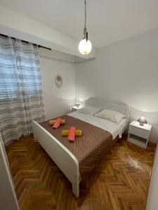 a bedroom with a bed with two pillows on it at Apartments Šestan in Novalja