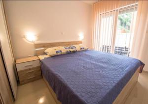 a bedroom with a blue bed with a window at Villa Karamba in Senj +97 photos