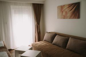 a living room with a couch and a window at Matino Apartment 1 in Valjevo +16 photos