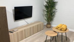 a living room with a flat screen tv on a wall at Apartamento Boutique Arquera Golf III in Llanes
