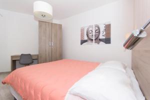 a bedroom with a bed and a picture on the wall at Alison Apartments in Premantura