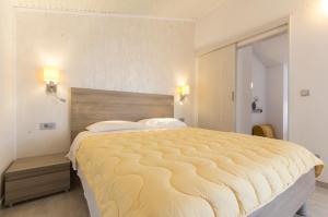 a bedroom with a large bed in a room at Alison Apartments in Premantura