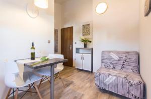 a small apartment with a bed and a table and chairs at Alison Apartments in Premantura