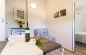 a bottle of wine on a table in a room at Alison Apartments in Premantura