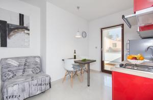 a kitchen with a sink and a table in a room at Alison Apartments in Premantura
