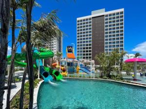 a pool with a water slide in a resort at Salinas Premium Resort in Salinópolis