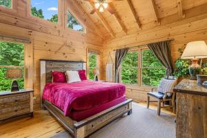 a bedroom with a bed and a desk and windows at Tatanka at LakeLure Rumbling Bald Hot Tub Fire Pit in Lake Lure +291 photos