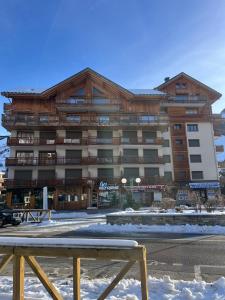 a large building with a table in front of it at Appartement 6 personnes pied des pistes in Les Deux Alpes +54 photos