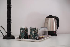 a table with a coffee maker and affeepot at Villa Rubino Mondello Guest house - By Rentalbeb Italy in Palermo
