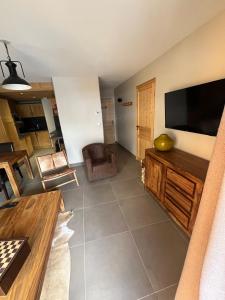 a living room with a large flat screen tv at Appartement 6 personnes pied des pistes in Les Deux Alpes