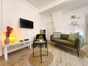 a living room with a couch and a table at Studio- Hyper Centre Ville in Colmar