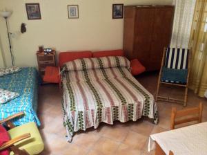 a bedroom with a bed and a table and chairs at Cozy Apartment by the Sea in Acireale