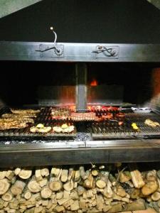 a grill with many different types of food in it at Hotel Parrilla el Zangano in Boal
