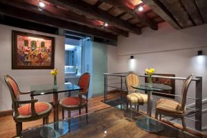 a room with two tables and chairs and a painting at San Telmo Suites in Buenos Aires