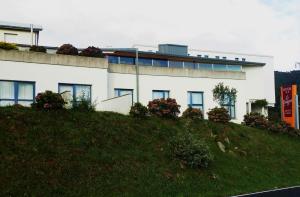 a white building on top of a hill at Hotel Parrilla el Zangano in Boal