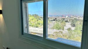 a window with a view of a city at Beautyful Resort Apartment in Haifa