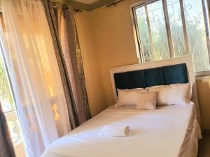 Ένα ή περισσότερα κρεβάτια σε δωμάτιο στο Haven Homes