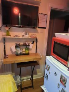 a small table in a room with a microwave at City centre room Ensuite in Cork