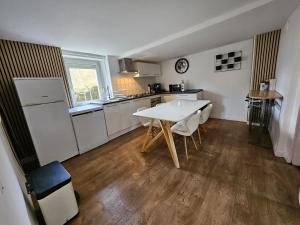 a kitchen with a white table and a white counter top at Maison à louer in Insming
