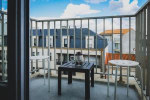a balcony with a table and two chairs on a balcony at Appartement Quartier les Presidents - 2-4 personnes in La Rudelière