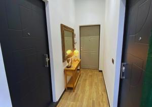 a hallway with a black door and a mirror at C'era un Voltino Guest House in Borgonovo