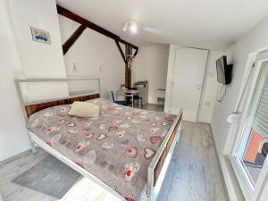 a bedroom with a bed with a comforter on it at Apartment By the River in Niš +122 photos