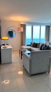 a living room with a couch and a table at Breathtaking Direct Bay Views 2 bedroom condo with parking in Miami
