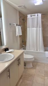 a bathroom with a toilet sink and a shower at Breathtaking Direct Bay Views 2 bedroom condo with parking in Miami