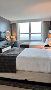a hotel room with two beds and a large window at Breathtaking Direct Bay Views 2 bedroom condo with parking in Miami +41 photos