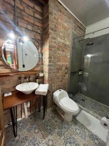 a bathroom with a sink and a toilet and a shower at Socialtel Candelaria Bogotá in Bogotá
