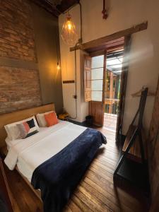 a bedroom with a large bed in a room at Socialtel Candelaria Bogotá in Bogotá