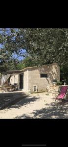 a small brick house with a pink chair in front of it at Villa la Roma in Aix-en-Provence