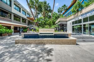 a bench in the middle of a sidewalk in front of a building at Bay View Beauty 1 Bedroom condo in Coconut Grove Parking Included in Miami