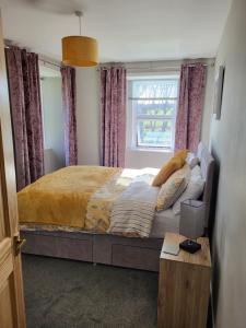 En eller flere senge i et værelse på Kirbister Mill Farm Cottage