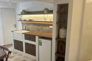 a kitchen with a sink and a dishwasher at Kampisma Project 2 in Dhriopís