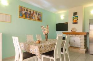 a dining room with a table with chairs and a fireplace at House Vila Petra in Blato
