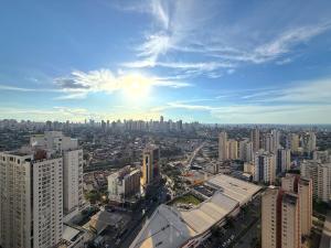 a view of a city with the sun in the sky at iFlat brookfield Towers BTLX2817 Jardim Goiás in Goiânia