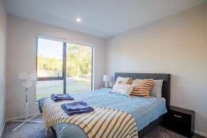 Ένα ή περισσότερα κρεβάτια σε δωμάτιο στο Zen Style 3 bedrooms near School, shop and Eateries