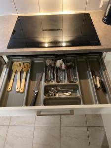 a drawer in a kitchen with utensils in it at Ferienhaus "LE RUISSEAU" Ihr großzügiges Ferienhaus in Badenweiler in Badenweiler